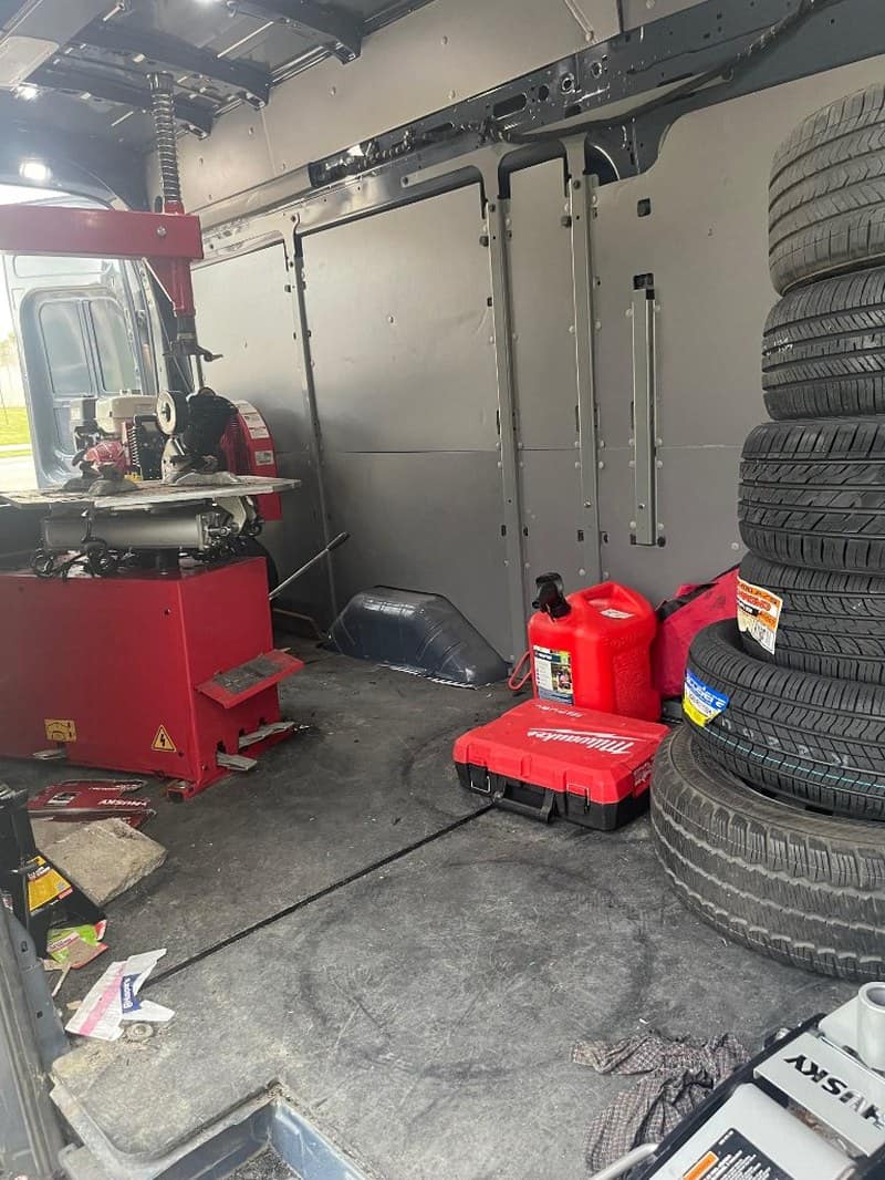 Mobile tire shop interior with tools and tires